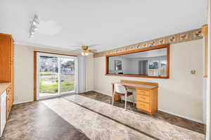 Unfurnished office featuring track lighting and ceiling fan