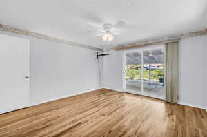 Spare room featuring ceiling fan and light hardwood / wood-style flooring