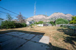 View of yard with a mountain view and a patio area