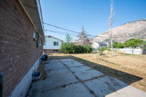 View of patio with central AC and a mountain view