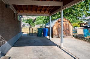 View of patio featuring a storage unit