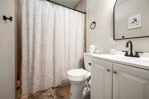 Bathroom with tile patterned floors, toilet, and vanity