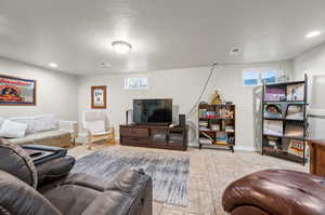 Living room featuring light tile patterned flooring and a wealth of natural light