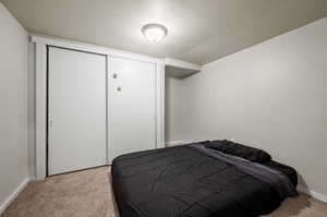 Bedroom featuring a closet and light colored carpet