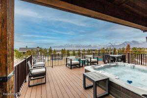 Wooden deck featuring a hot tub