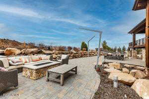 View of patio featuring an outdoor living space with a fire pit