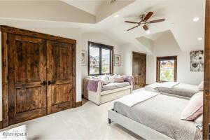 Bedroom featuring ceiling fan and vaulted ceiling