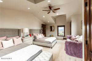 Bedroom with lofted ceiling and ceiling fan