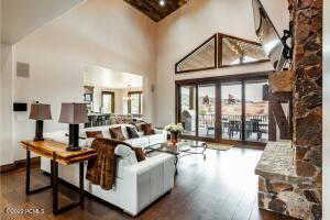 Living room with hardwood / wood-style floors and high vaulted ceiling