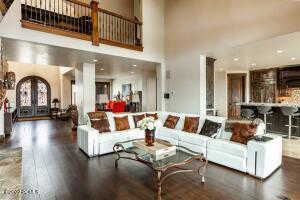 Living room with dark hardwood / wood-style flooring, french doors, and a towering ceiling