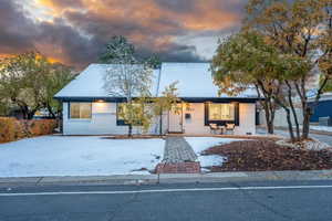 View of front of house featuring covered porch and central AC