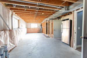 Basement with stainless steel fridge