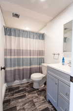 Bathroom featuring tile patterned floors, toilet, and vanity