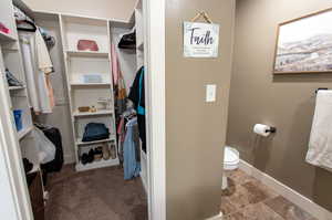 Walk in closet with tile patterned flooring