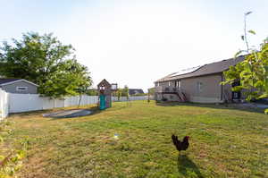 View of yard with a wooden deck