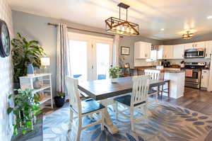 Dining area with dark wood-type flooring, french doors, and sink