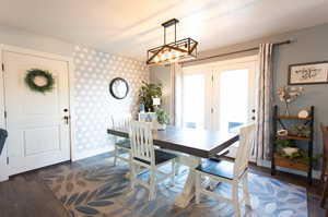 Dining space with dark hardwood / wood-style floors and french doors