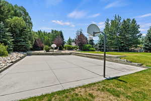 View of basketball court with a yard and volleyball court