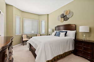 Bedroom featuring light colored carpet