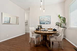 Dining space featuring dark wood-type flooring