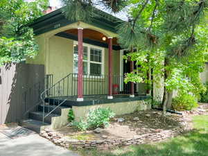 Doorway to property with covered porch