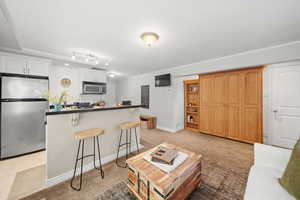 Open-concept living area with new paint and a built-in Murphy bed and shelving