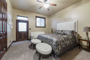 Carpeted bedroom featuring ceiling fan