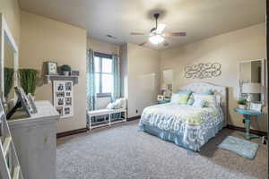 Carpeted bedroom with ceiling fan