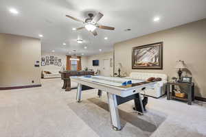 Rec room with light carpet, ceiling fan, and billiards