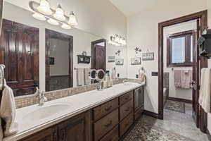 Bathroom featuring tile patterned flooring and dual vanity