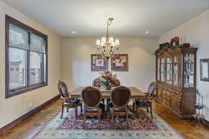 Dining space with parquet floors and an inviting chandelier