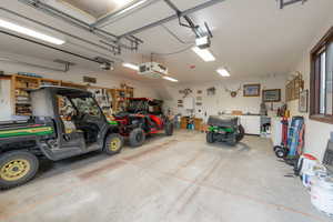 Garage featuring a garage door opener and a workshop area