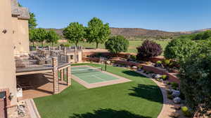 View of home's community featuring a mountain view and a yard