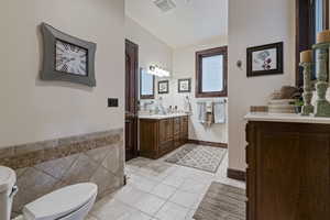 Bathroom with tile patterned floors, vanity, and toilet