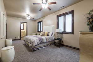 Carpeted bedroom with ceiling fan