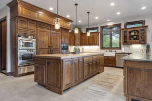 Kitchen featuring stainless steel appliances, tasteful backsplash, and a kitchen island