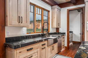 Kitchen featuring beamed ceiling, wooden ceiling, light brown cabinetry, and dark hardwood / wood-style floors