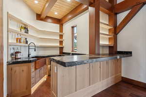 Bar featuring beam ceiling, light brown cabinets, wood ceiling, dark hardwood / wood-style floors, and sink