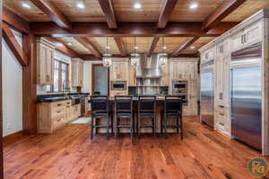 Kitchen featuring a center island, appliances with stainless steel finishes, wooden ceiling, and hardwood / wood-style floors