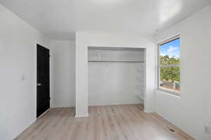 Large Upstairs Bedroom with Lots of Natural Light.  Note the. closet shelving