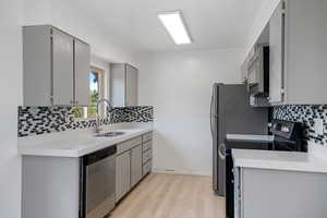 Updated Kitchen, Quartz Countertops, Tile Backsplash.  Appliances Stay!