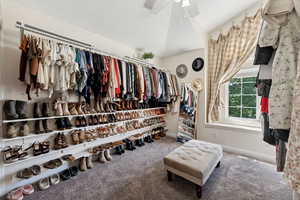 This bedroom is being used as a large closet space for clothes and shoes