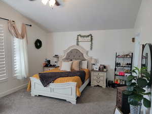 HUGE Bedroom featuring carpet flooring, lofted ceiling, and ceiling fan.  You may not have ever seen a bedroom this big...