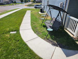 sidewalk leading to entry of apartment.