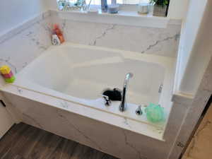 Bathroom featuring hardwood / wood-style flooring and a bathing tub