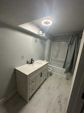 Full bathroom featuring vanity, shower / bath combo with shower curtain, a textured ceiling, and toilet