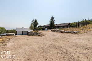 View of yard with a garage and an outbuilding