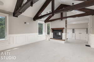 Primary bedroom featuring plenty of natural light, high vaulted ceiling, carpet flooring, and beam ceiling