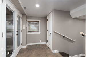 Hallway featuring dark tile patterned floors