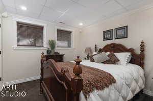 Carpeted bedroom featuring a paneled ceiling